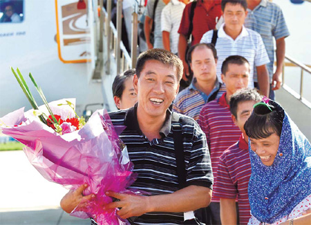 Chartered flight brings crew home