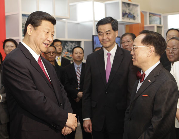 Vice-President Xi Jinping, accompanied by Hong Kong Chief Executive-Elect Leung Chun-ying, talks with Hong Kong Chief Executive Donald Tsang at the National Museum of China in Beijing on Wednesday. The museum is featuring an exhibition celebrating Hong Kong's achievements in the past 15 years. Sheng Jiapeng/China News Service Yuan trade settlements encouraged in SAR