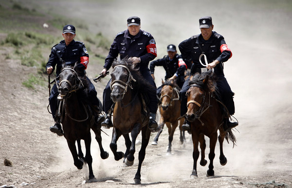 Police patrol on horseback in Xinjiang