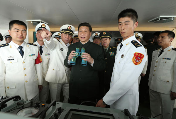 Xi Jinping, general secretary of the Communist Party of China Central Committee and chairman of the CPC Central Military Commission, boards a PLA Navy destroyer, the Haikou, during his inspection on PLA units in Guangdong province, Dec 8, 2012. Xi orders PLA to become ready for 'real combat'