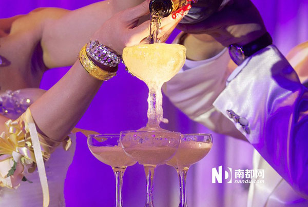 Newly wed lesbian partners, 36-year-old Dongdong (alias) and 30-year-old Qiqi (alias), pour champagne into a goblet-tower at their wedding in Shenzhen city, South China's Guangdong province on Jan 4, 2013. First public lesbian wedding held in S China
