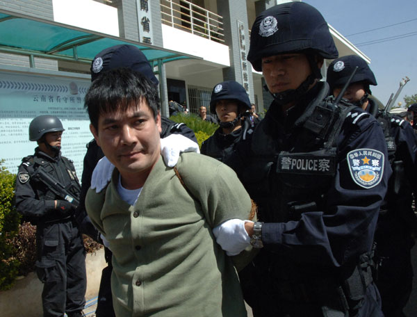 Drug lord Naw Kham, from Myanmar, is escorted to an execution room in Kunming, Yunnan province, on Friday. Zhao Haolin / for China Daily Drug lord and 3 accomplices executed