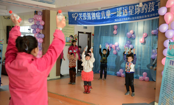 Children suffering from autism perform on a stage in a rehabilitation center in Harbin city, Northeast China's Heilongjiang provine on April 2, 2013. Caring for autistic children