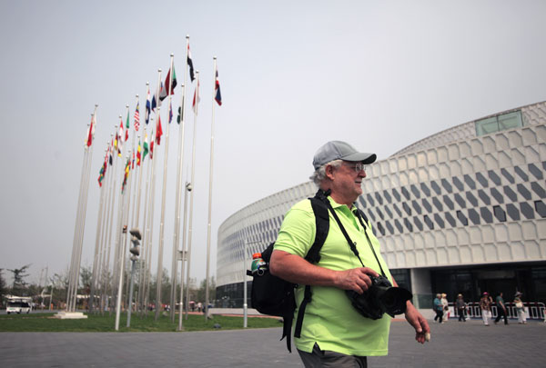 A foreign tourist walks outside the main exhibition hall of the expo. Beijing hosts garden expo