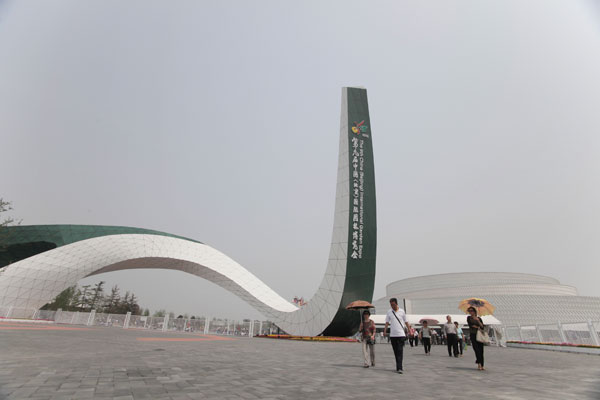 People walk out of the gate of the garden expo. Beijing hosts garden expo