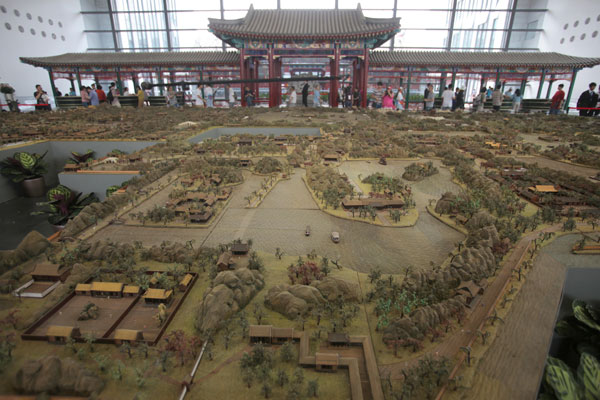 Tourists visit a miniature of the old Summer Palace in the Museum of Chinese Gardens inside the garden expo. Beijing hosts garden expo