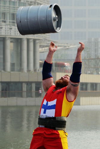 A competitor competes in the keg toss event during the World's Strongest Man Competition in Zhengzhou, Henan province, on July 6, 2013. Herculean effort