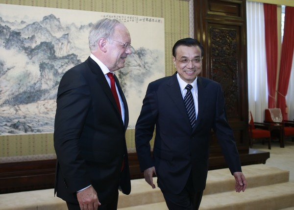 Premier Li Keqiang and Johann Schneider-Ammann, Federal Councillor and Head of the Federal Department of Economic Affairs of Switzerland, smile after the signing ceremony of China's first free trade agreement with a continental European nation. Feng Yongbin / China Daily Sino-Swiss free trade pact signed in Beijing
