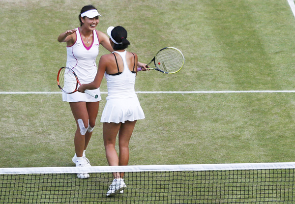 Peng Shuai of the Chinese mainland (L) and Hsieh Su-Wei of Taiwan celebrate after defeating Ashleigh Barty of Australia and Casey Dellacqua of Australia in their women's doubles final tennis match at the Wimbledon Tennis Championships, in London on July 6, 2013. Peng, Hsieh win Wimbledon doubles, creating history