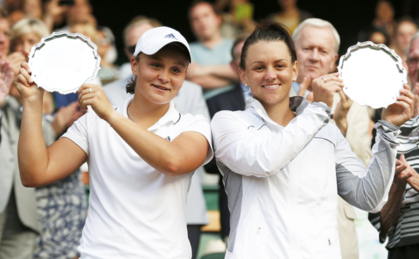 Ashleigh Barty of Australia (L) and Casey Dellacqua of Australia hold their runners-up trophies after being defeated by Peng Shuai of the Chinese mainland and Hsieh Su-Wei of Taiwan in their women's doubles final tennis match at the Wimbledon Tennis Championships, in London July 6, 2013. Peng, Hsieh win Wimbledon doubles, creating history
