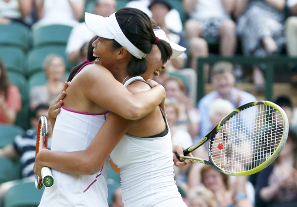 Peng Shuai of the Chinese mainland (L) and Hsieh Su-Wei of Taiwan celebrate after defeating Ashleigh Barty of Australia and Casey Dellacqua of Australia in their women's doubles final tennis match at the Wimbledon Tennis Championships, in London July 6, 2013. Peng, Hsieh win Wimbledon doubles, creating history