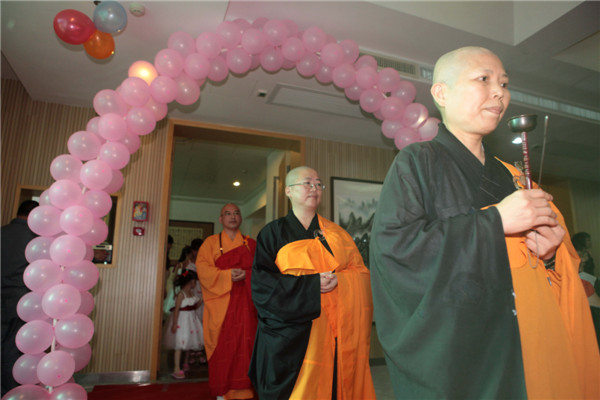 Buddhist masters attend the first formal Buddhism wedding in Xiamen city, Fujian province on July 6, 2013. Buddhist wedding chimes in E China