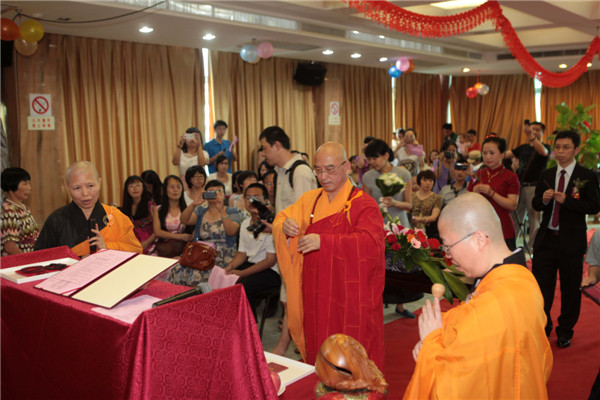 Buddhist masters chant scripture and burn incense at a wedding in Xiamen city, Fujian province on July 6, 2013. Buddhist wedding chimes in E China