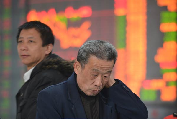 Two men watch the stock market at a broker’s office in Fuyang, Anhui province on Friday. The IPO reform plan, which was released on Nov 30, was widely welcomed by the market. CSRC to boost IPO reform plan
