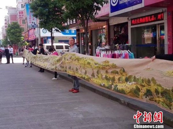 Woman embroiders giant painting