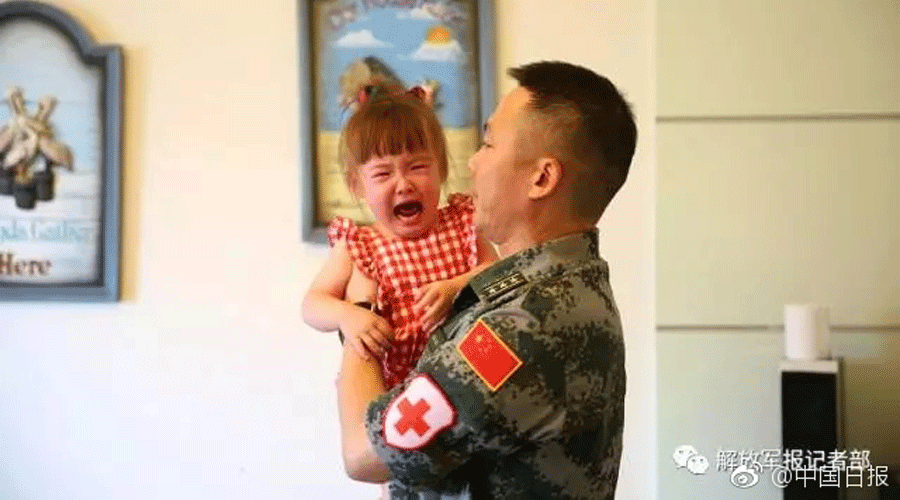 Sad farewell: Daughters say goodbye to peacekeeping soldier