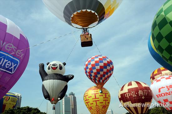 Hot air balloons color S China city sky