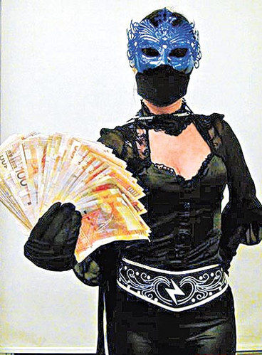 Masked woman claims she hands out money to the poor