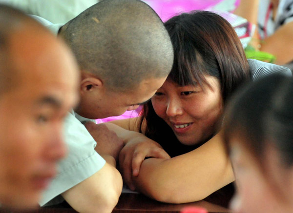 An inmate talks to his fiancée to celebrate the upcoming Chinese Valentine's Day, Qixi Festival, which falls on the seventh day of the seventh month on the Chinese lunar calendar, August 6 this year, at a prison in Xinyang, Central China's Henan province, August 3, 2011. Celebrating Chinese Valentine's Day behind bars