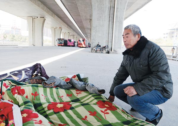 Migrant workers shelter beneath overpasses