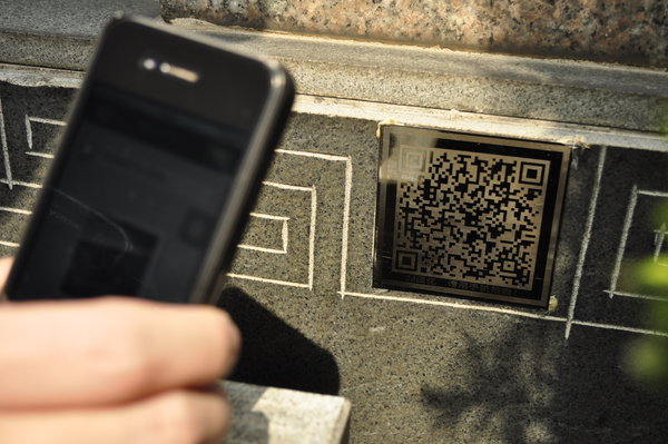 A smartphone is used to scan a QR code containing more information about the dead person in Ningbo, March 28, 2013. Matrix barcodes on tombs