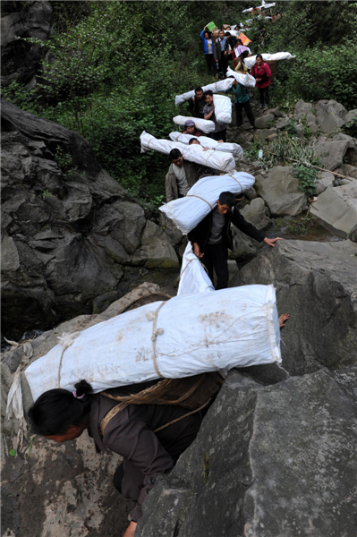 Villagers climb mountains to get relief supplies