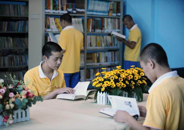 Youngsters recovering from drug addiction read books at a rehab center in Shanxi, June 13, 2013. Battling addiction with compulsory detox