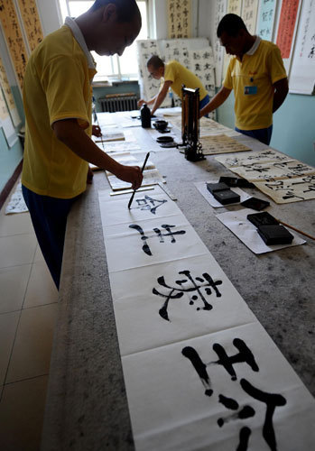 Youngsters recovering from drug addiction practice calligraphy at a rehab center in Shanxi, June 13, 2013. Battling addiction with compulsory detox