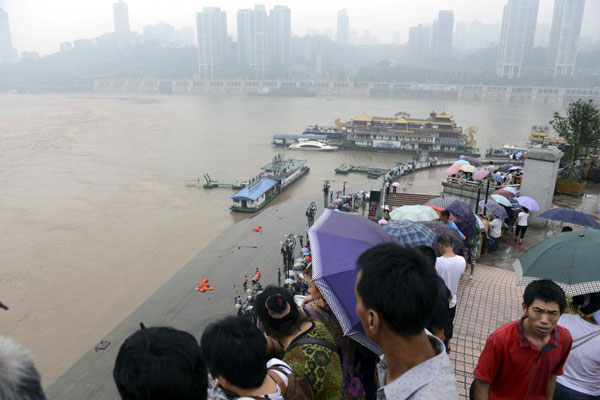 5 missing after floodwaters sink barge in SW China
