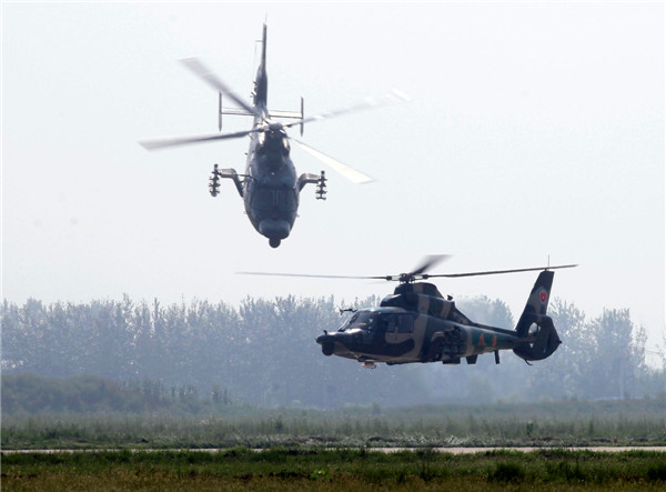 Helicopters practice acrobatic moves for expo