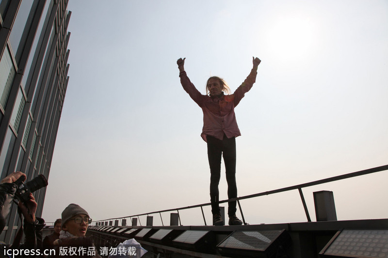 French 'spiderman' scales 288m-tall building in E China