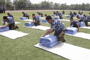 Military training with bottles balanced on heads