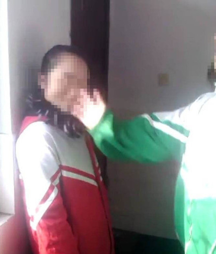 Students slap girl for wearing wrong trousers