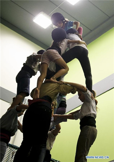 Chinese girl in local Spanish human tower team