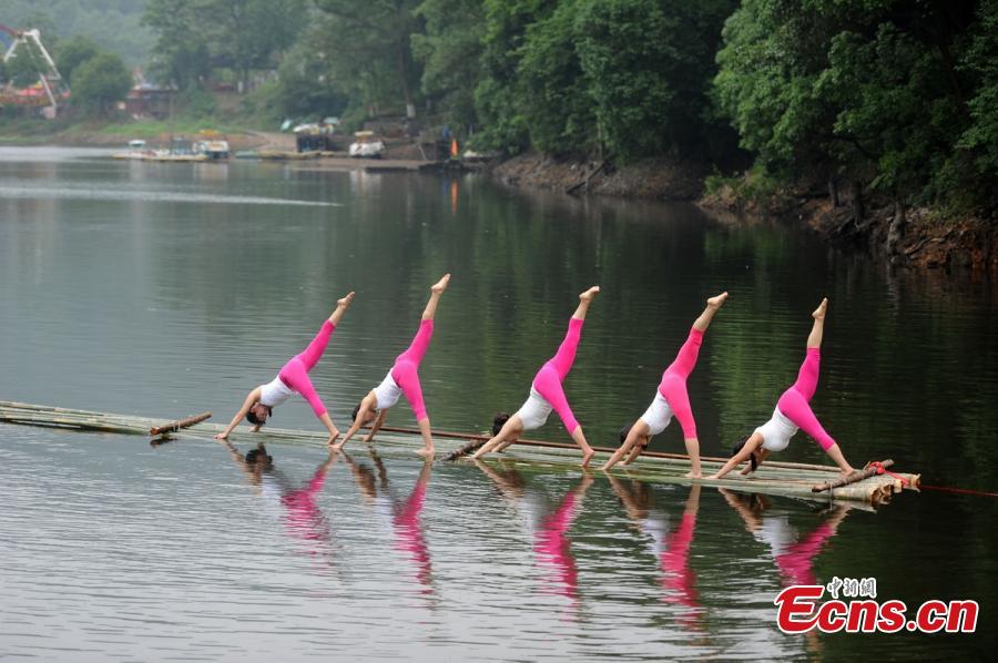 Yoga enthusiasts dance in water