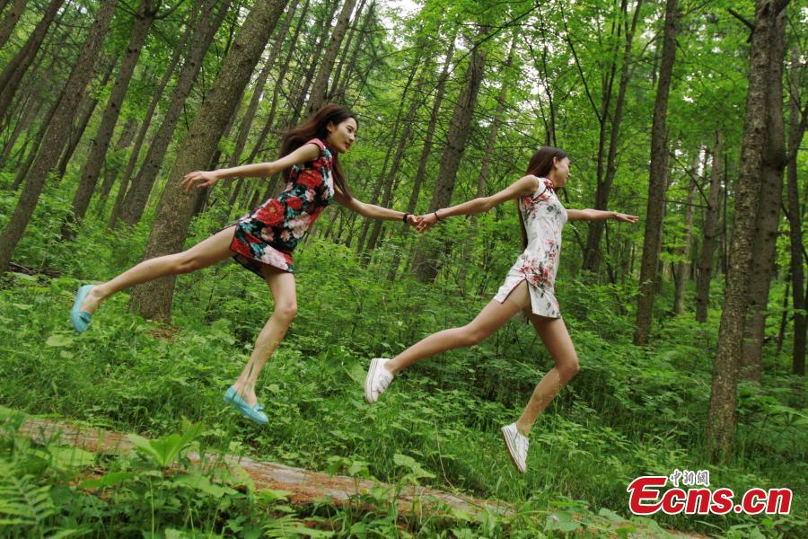 <EM>Qipao</EM>-clad students float in forest