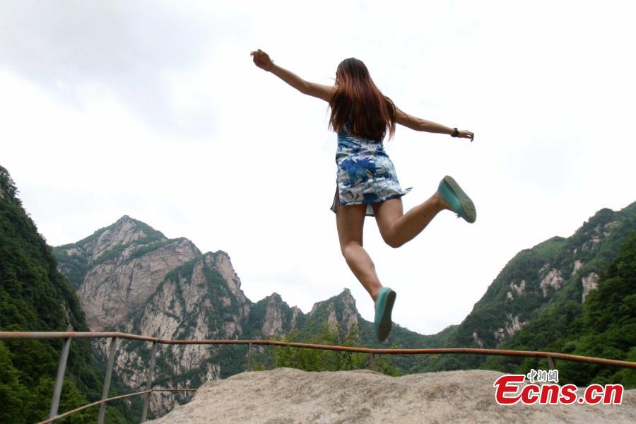 <EM>Qipao</EM>-clad students float in forest