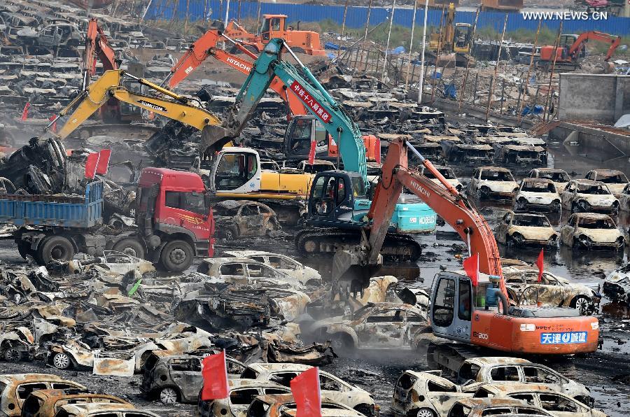 Burnt vehicles cleaned up in core blast area in Tianjin