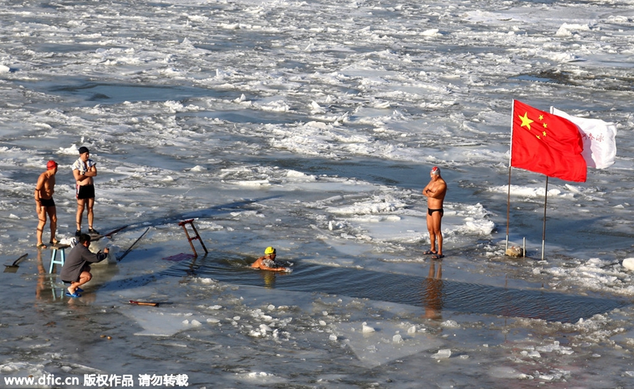 Swimmers battle against the cold in ice-covered river