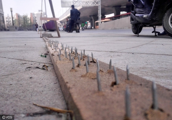 Nail planks placed at street to stop wrongly parked cars