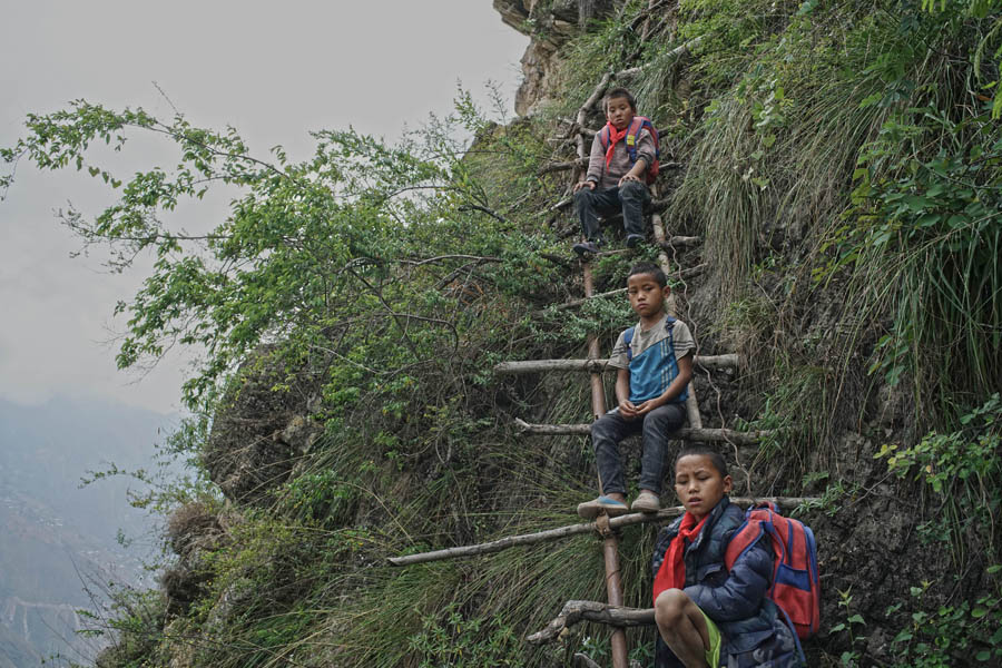 Children scale 800-meter cliff on way to school