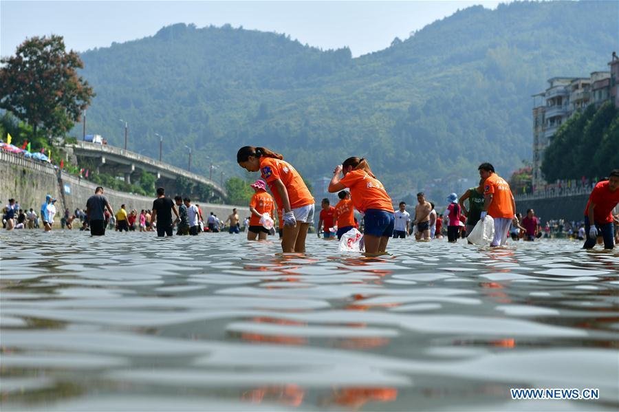 People catch fish in river to celebrate good harvest