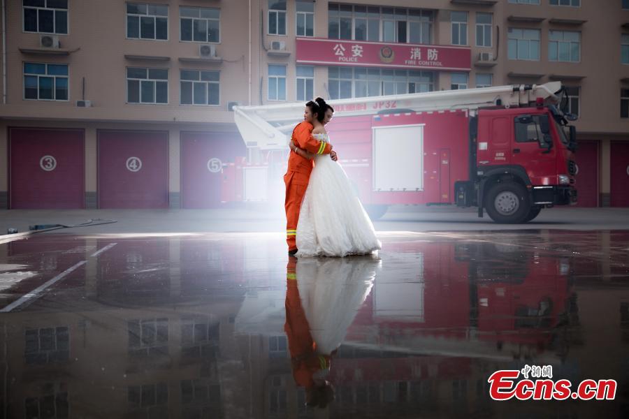 Firefighter poses for unconventional wedding photos