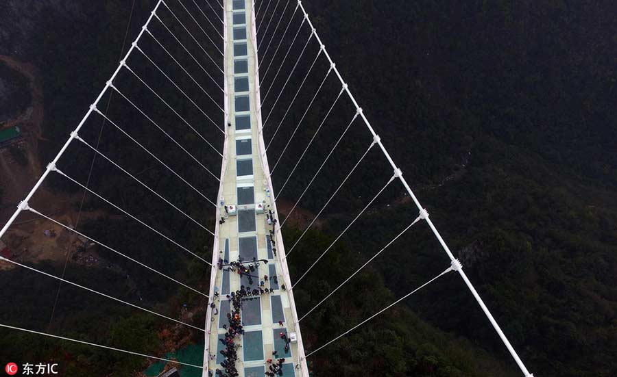 Man braves ice to set new record on world's highest glass bridge