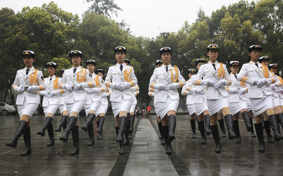 Marching in step: Female college students form flag-raising team