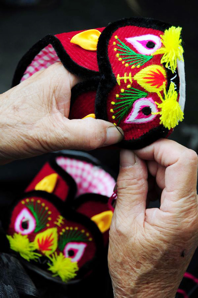 Traditional hand-made boots and hats with tiger images