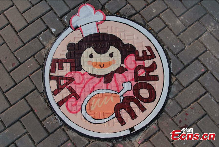Students paint dream on manhole covers