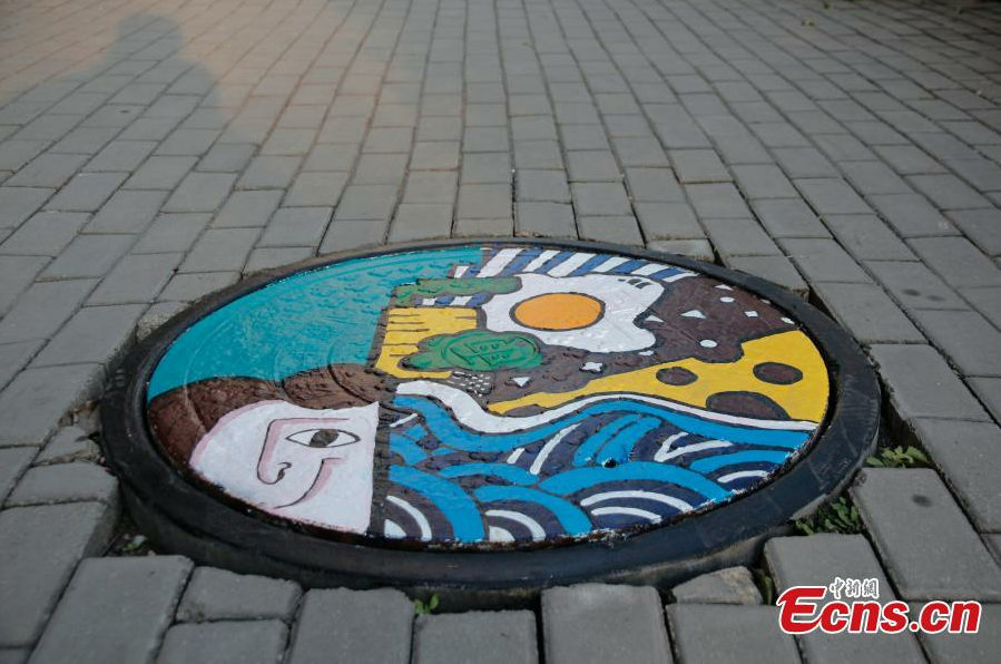 Students paint dream on manhole covers