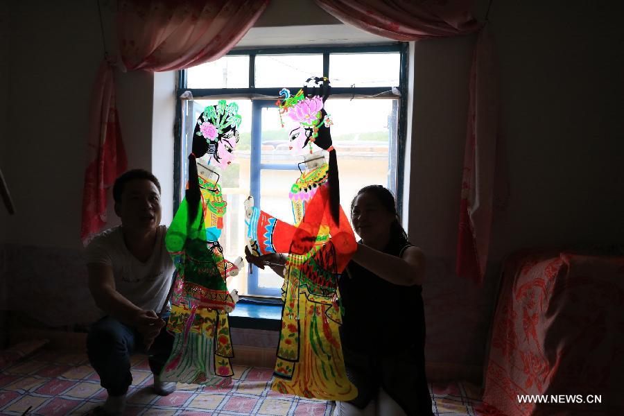 Successor of intangible cultural heritage of shadow play performs in NE China