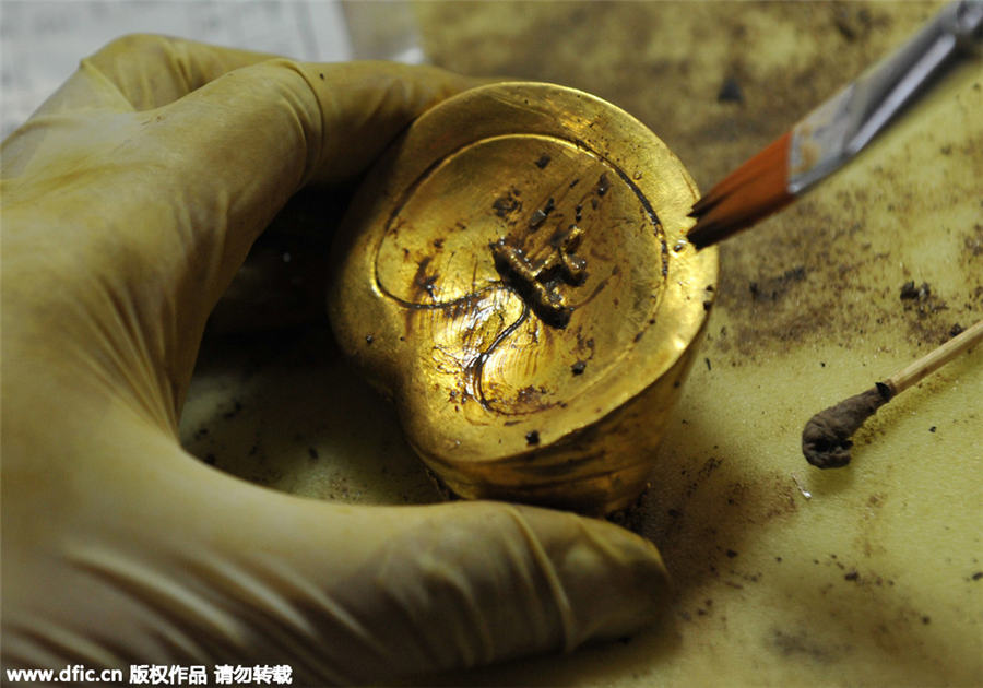 Goldware inscribed with characters unearthed from ancient cemetery